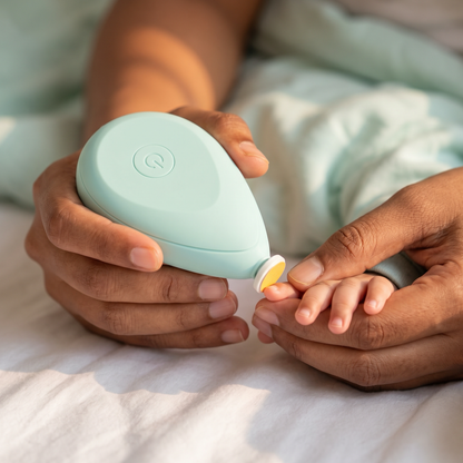 Parent filing a baby's fingernail with the electric trimmer