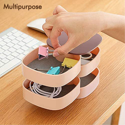 Rotating box holding clips and cables on a desk